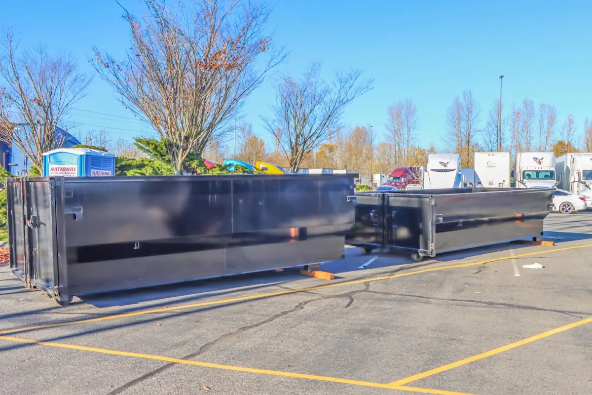 Professional dumpster rental service with roll-off container on residential driveway in Loughman